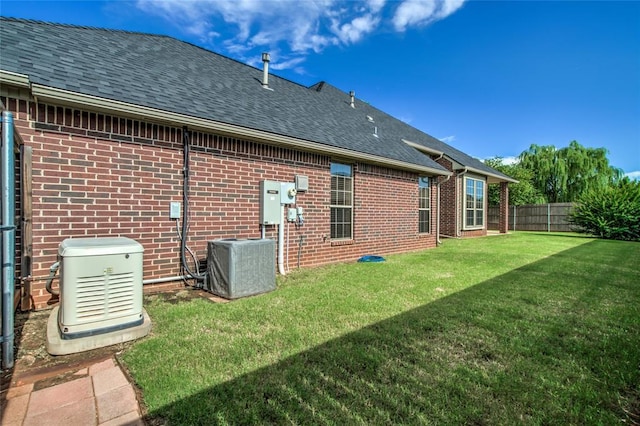 1704 NW 171st St, Edmond, OK 73012 - back of house featuring brick siding and a shingled roof