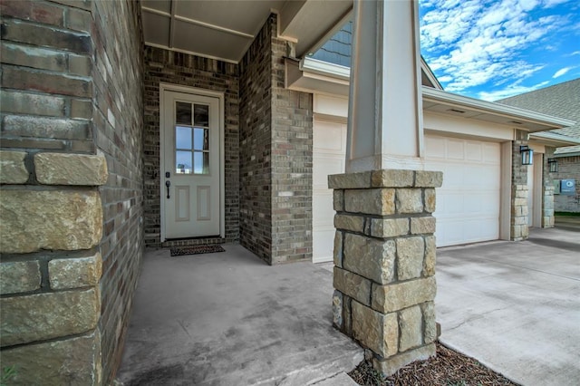 18445 Austin Pl, Edmond, OK 73012 - entrance to property featuring driveway, a garage, and brick siding
