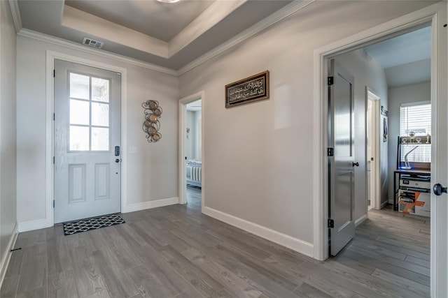18445 Austin Pl, Edmond, OK 73012 - entrance foyer featuring wood finished floors, a tray ceiling, and crown molding