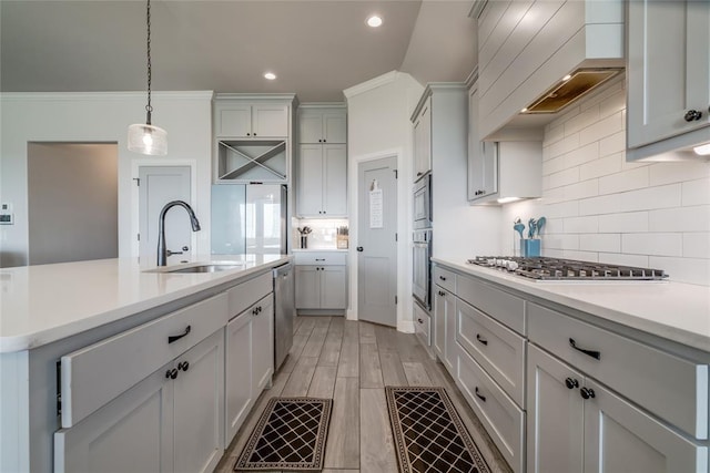 18445 Austin Pl, Edmond, OK 73012 - kitchen with stainless steel appliances, light countertops, custom exhaust hood, backsplash, and hanging light fixtures