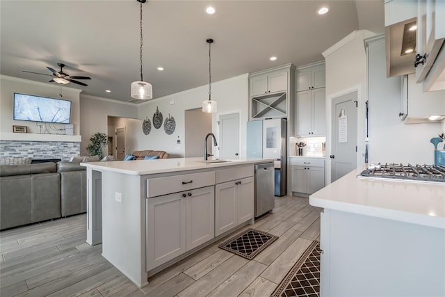 18445 Austin Pl, Edmond, OK 73012 - kitchen with appliances with stainless steel finishes, a ceiling fan, light wood finished floors, ornamental molding, and light countertops