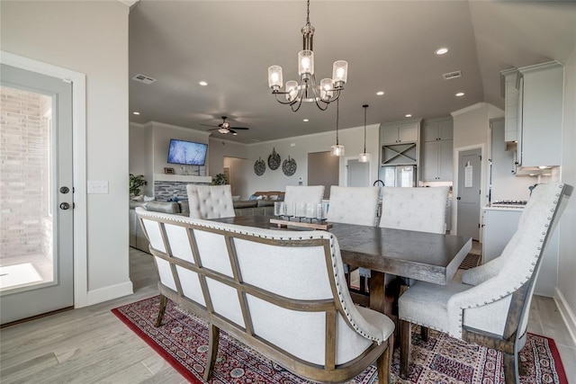 18445 Austin Pl, Edmond, OK 73012 - dining space featuring a ceiling fan, light wood finished floors, a chandelier, recessed lighting, and crown molding