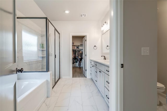 18445 Austin Pl, Edmond, OK 73012 - full bath with a garden tub, marble finish floors, a stall shower, vanity, and recessed lighting
