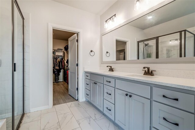 18445 Austin Pl, Edmond, OK 73012 - full bathroom with a walk in closet, double vanity, a stall shower, and marble finish floors