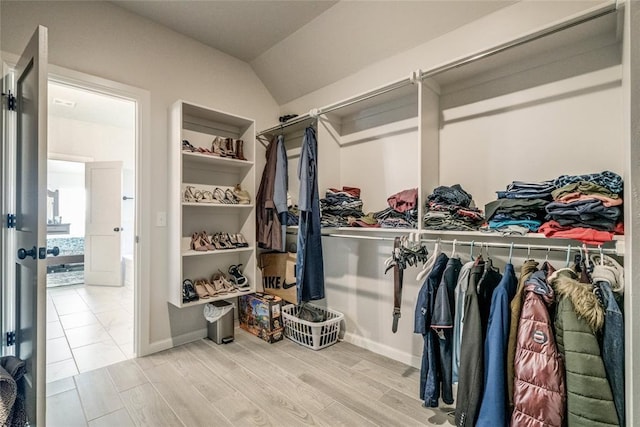 18445 Austin Pl, Edmond, OK 73012 - spacious closet featuring wood finished floors and lofted ceiling