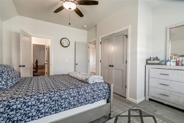 18445 Austin Pl, Edmond, OK 73012 - bedroom with wood finished floors, a closet, and a ceiling fan