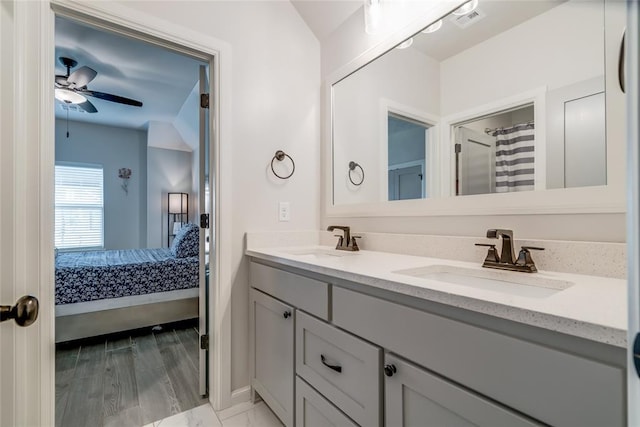 18445 Austin Pl, Edmond, OK 73012 - bathroom with ensuite bath, double vanity, and ceiling fan