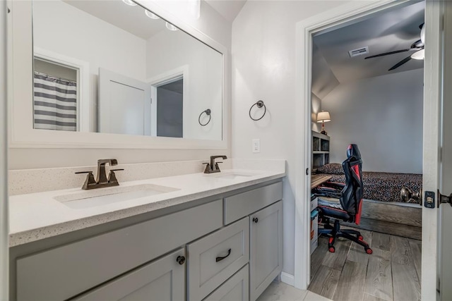 18445 Austin Pl, Edmond, OK 73012 - full bath featuring double vanity, a ceiling fan, and wood finished floors