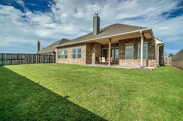 18445 Austin Pl, Edmond, OK 73012 - rear view of house with a patio area, a chimney, a fenced backyard, and brick siding