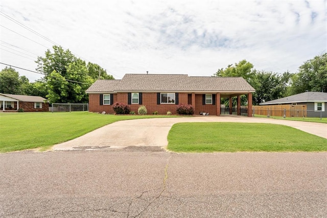 116 E Juniper Ln, Mustang, OK 73064 - ranch-style home with concrete driveway, brick siding, and an attached carport