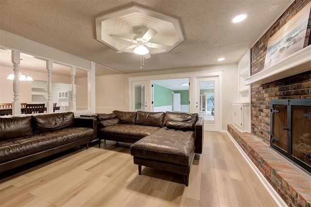 3725 N Grant Ave, Bethany, OK 73008 - living room featuring a fireplace, a textured ceiling, light wood-type flooring, ceiling fan, and recessed lighting
