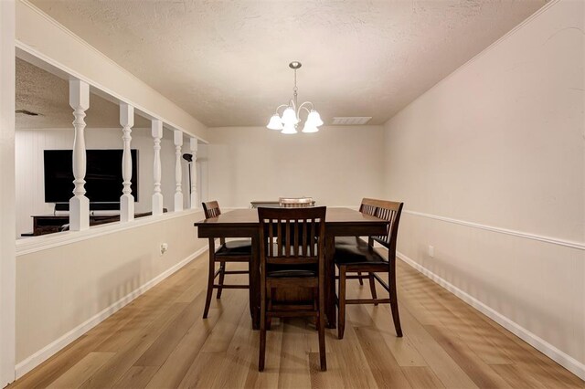 3725 N Grant Ave, Bethany, OK 73008 - dining space with light wood-style floors, a chandelier, and a textured ceiling