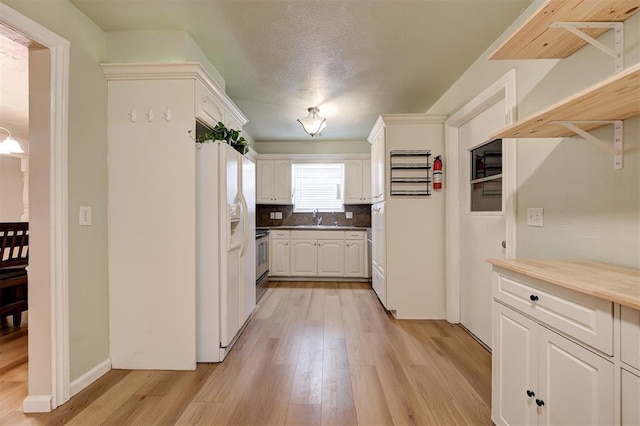 3725 N Grant Ave, Bethany, OK 73008 - kitchen with white refrigerator with ice dispenser, range, light wood-style floors, white cabinetry, and backsplash
