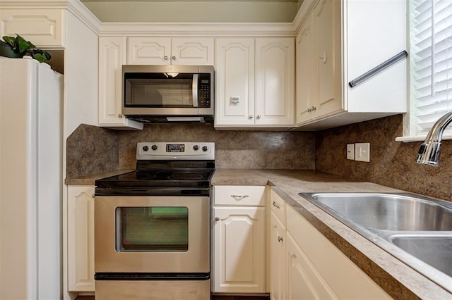 3725 N Grant Ave, Bethany, OK 73008 - kitchen with appliances with stainless steel finishes, decorative backsplash, white cabinetry, and light countertops
