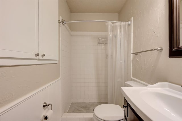 3725 N Grant Ave, Bethany, OK 73008 - full bathroom featuring tiled shower, vanity, and a textured wall
