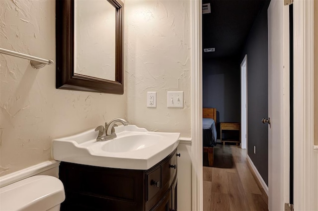 3725 N Grant Ave, Bethany, OK 73008 - bathroom featuring wood finished floors and vanity