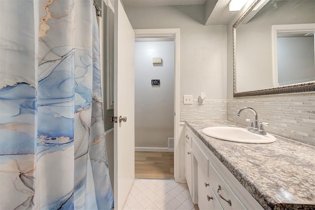 3725 N Grant Ave, Bethany, OK 73008 - bathroom featuring vanity, decorative backsplash, and tile patterned flooring