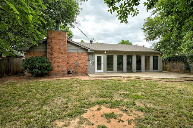 3725 N Grant Ave, Bethany, OK 73008 - rear view of house featuring a patio area, brick siding, and a chimney