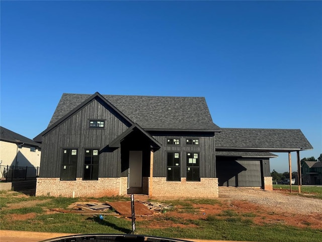 5901 Calcutta Ln, Edmond, OK 73025 - modern inspired farmhouse featuring brick siding, a garage, roof with shingles, and driveway