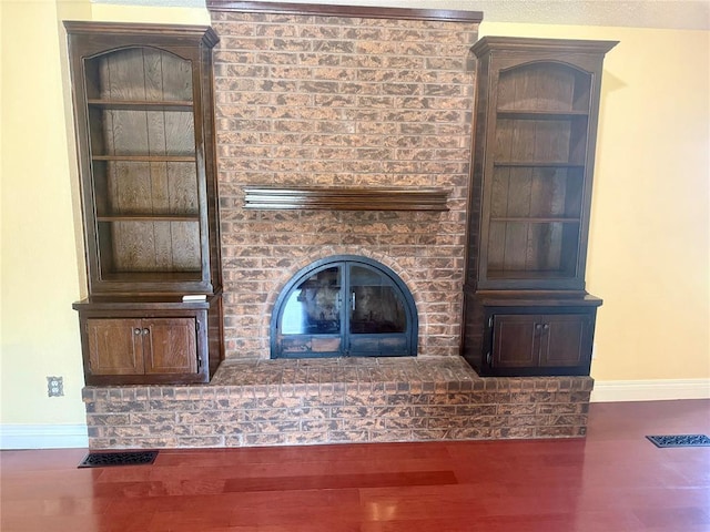 2608 SW 93rd, Oklahoma City, OK 73159 - unfurnished living room with wood finished floors and a fireplace