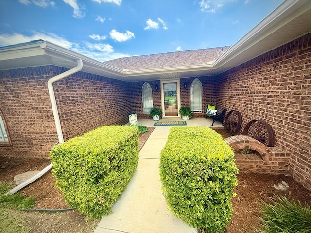 2608 SW 93rd, Oklahoma City, OK 73159 - doorway to property featuring brick siding and a shingled roof