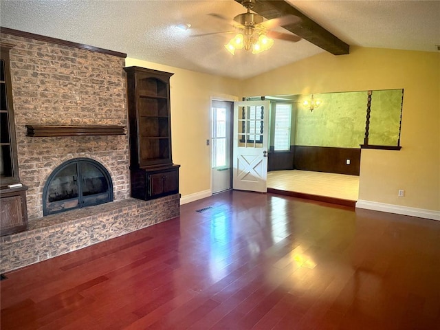 2608 SW 93rd, Oklahoma City, OK 73159 - unfurnished living room with a ceiling fan, wood finished floors, a textured ceiling, and a fireplace