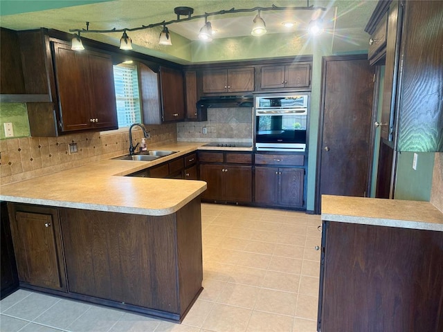 2608 SW 93rd, Oklahoma City, OK 73159 - kitchen with oven, tasteful backsplash, under cabinet range hood, and black cooktop