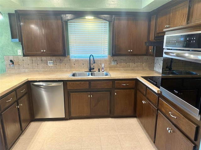 2608 SW 93rd, Oklahoma City, OK 73159 - kitchen with stainless steel appliances, tasteful backsplash, light countertops, and dark brown cabinetry
