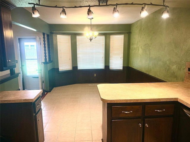 2608 SW 93rd, Oklahoma City, OK 73159 - kitchen featuring dark brown cabinets, a peninsula, pendant lighting, light countertops, and rail lighting