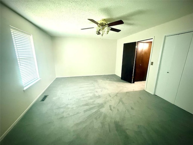 2608 SW 93rd, Oklahoma City, OK 73159 - unfurnished bedroom featuring carpet floors, multiple closets, ceiling fan, and a textured ceiling