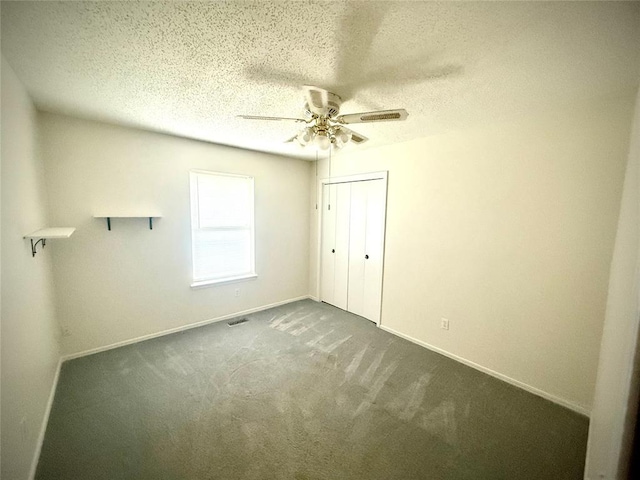2608 SW 93rd, Oklahoma City, OK 73159 - unfurnished bedroom featuring a textured ceiling, dark carpet, a closet, and a ceiling fan