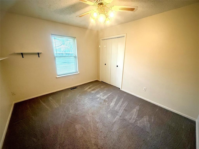 2608 SW 93rd, Oklahoma City, OK 73159 - unfurnished bedroom featuring dark carpet, a textured ceiling, a closet, and ceiling fan