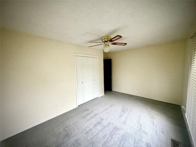 2608 SW 93rd, Oklahoma City, OK 73159 - unfurnished bedroom featuring carpet floors, a closet, a textured ceiling, and ceiling fan