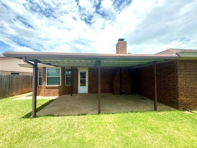 2608 SW 93rd, Oklahoma City, OK 73159 - back of property with a chimney, brick siding, and a patio area