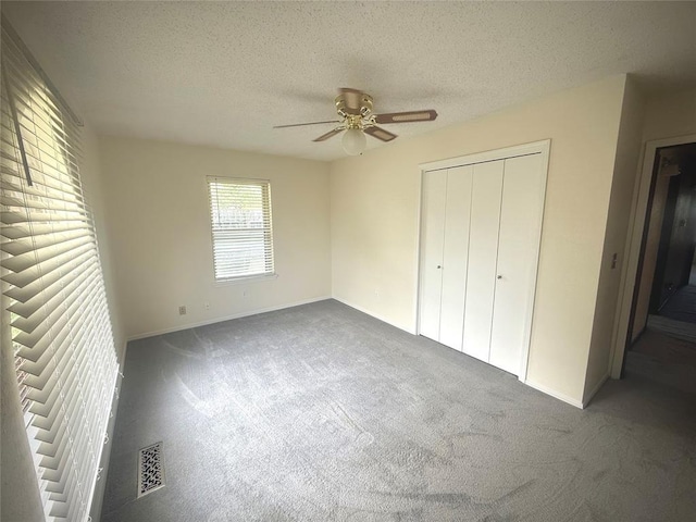 2608 SW 93rd, Oklahoma City, OK 73159 - unfurnished bedroom with carpet flooring, a textured ceiling, a closet, and a ceiling fan