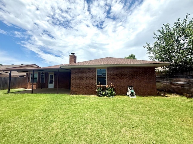 2608 SW 93rd, Oklahoma City, OK 73159 - back of property featuring a chimney, brick siding, and a patio