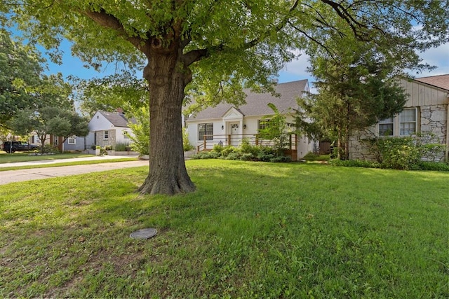 536 NW 48th St, Oklahoma City, OK 73118 - obstructed view of property with stone siding, a front lawn, and concrete driveway
