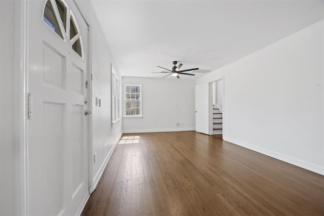 536 NW 48th St, Oklahoma City, OK 73118 - unfurnished room with a ceiling fan, dark wood-type flooring, and stairway