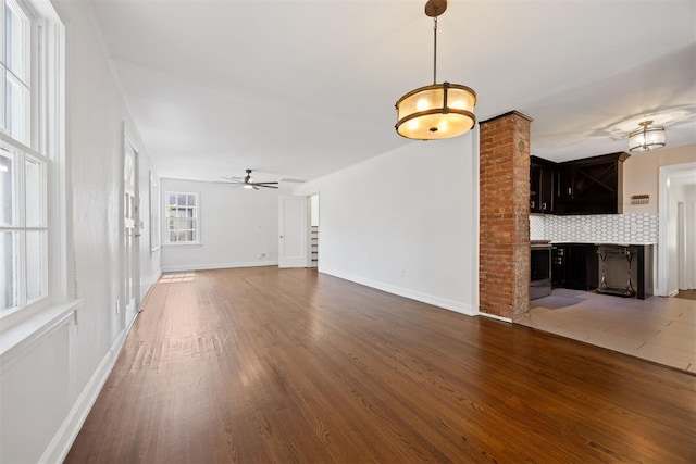 536 NW 48th St, Oklahoma City, OK 73118 - unfurnished living room with wood finished floors and ceiling fan