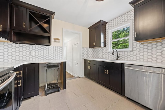 536 NW 48th St, Oklahoma City, OK 73118 - kitchen with appliances with stainless steel finishes, light countertops, and decorative backsplash