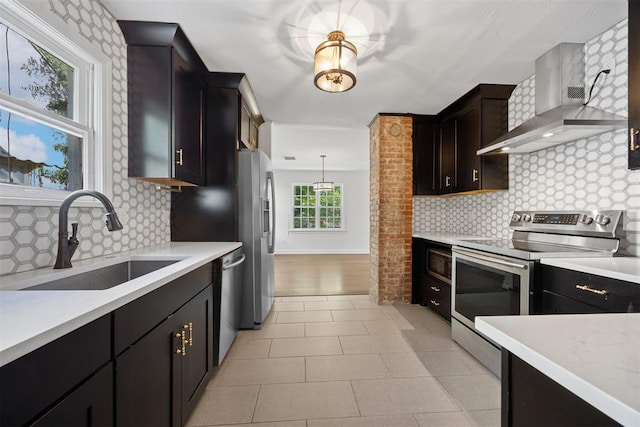 536 NW 48th St, Oklahoma City, OK 73118 - kitchen with stainless steel appliances, wall chimney exhaust hood, light countertops, and decorative backsplash