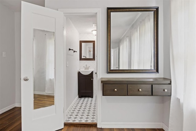 536 NW 48th St, Oklahoma City, OK 73118 - bathroom with vanity, wood finished floors, and tasteful backsplash