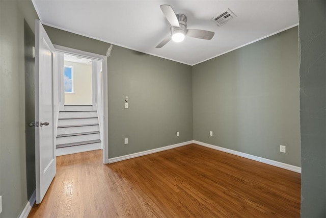 536 NW 48th St, Oklahoma City, OK 73118 - spare room with crown molding, ceiling fan, wood finished floors, and stairway
