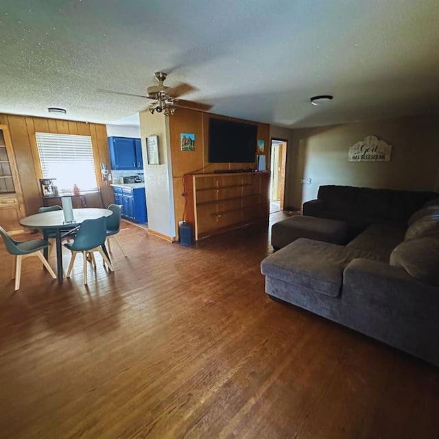 701 S 18th St, Clinton, OK 73601 - living area featuring dark wood-style floors, a ceiling fan, and a textured ceiling