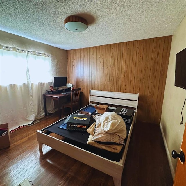 701 S 18th St, Clinton, OK 73601 - bedroom featuring a textured ceiling, wood finished floors, and wood walls
