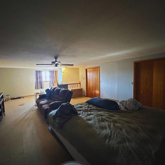 701 S 18th St, Clinton, OK 73601 - bedroom with a textured ceiling, light carpet, and a ceiling fan