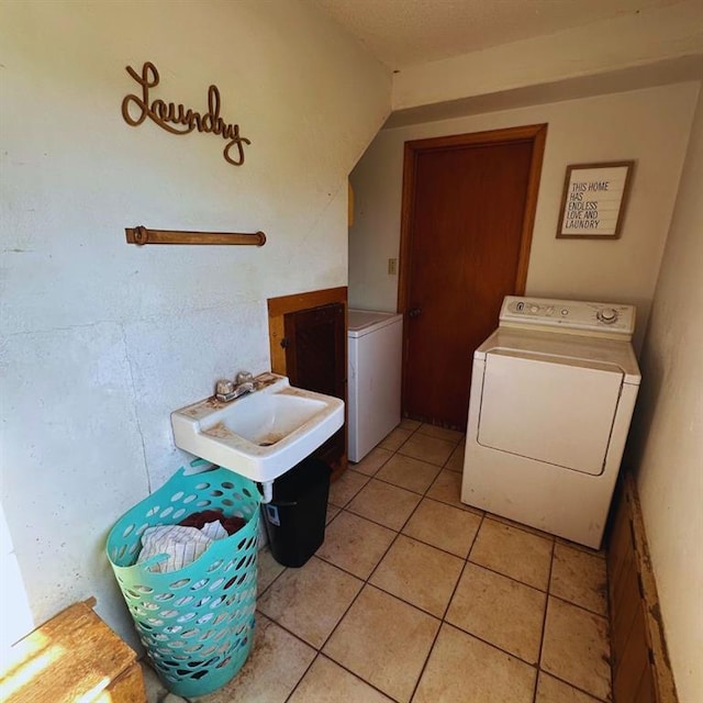 701 S 18th St, Clinton, OK 73601 - washroom featuring washer / dryer and light tile patterned floors