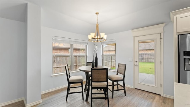 3021 NW 179th Ct, Edmond, OK 73012 - dining room featuring a chandelier and light wood-style flooring