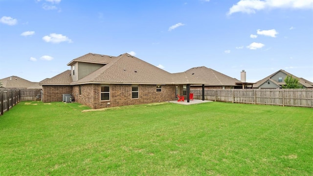 3021 NW 179th Ct, Edmond, OK 73012 - back of property with a fenced backyard, brick siding, a patio, and a shingled roof