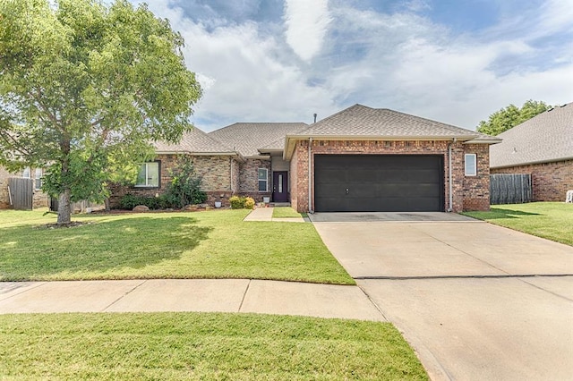 17425 White Hawk Dr, Edmond, OK 73012 - view of front of house with an attached garage, driveway, brick siding, and roof with shingles